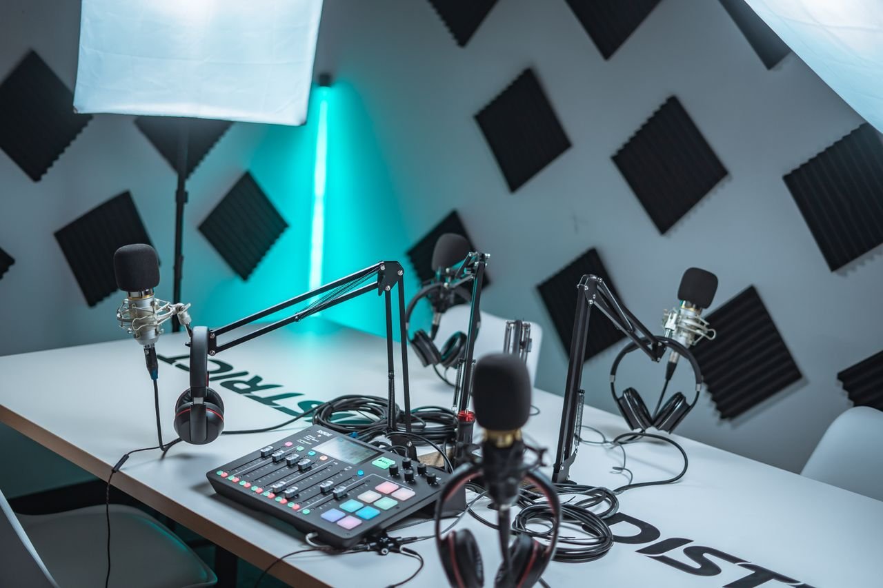 Services Sleek podcast studio setup featuring microphones, audio mixer, and acoustic panels.