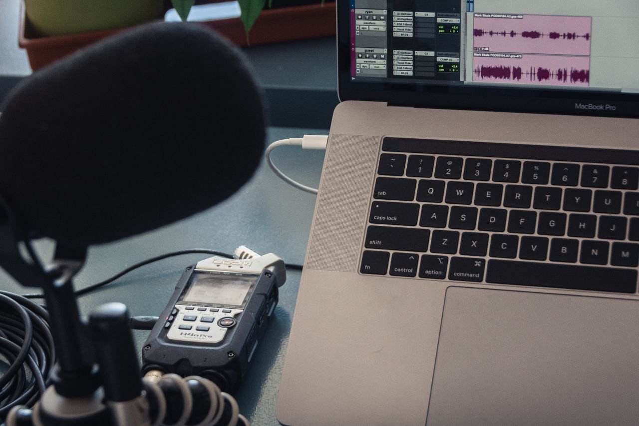 Crafting Captivating Headlines: Your awesome post title goes here Microphone and laptop setup for audio recording in a studio environment.